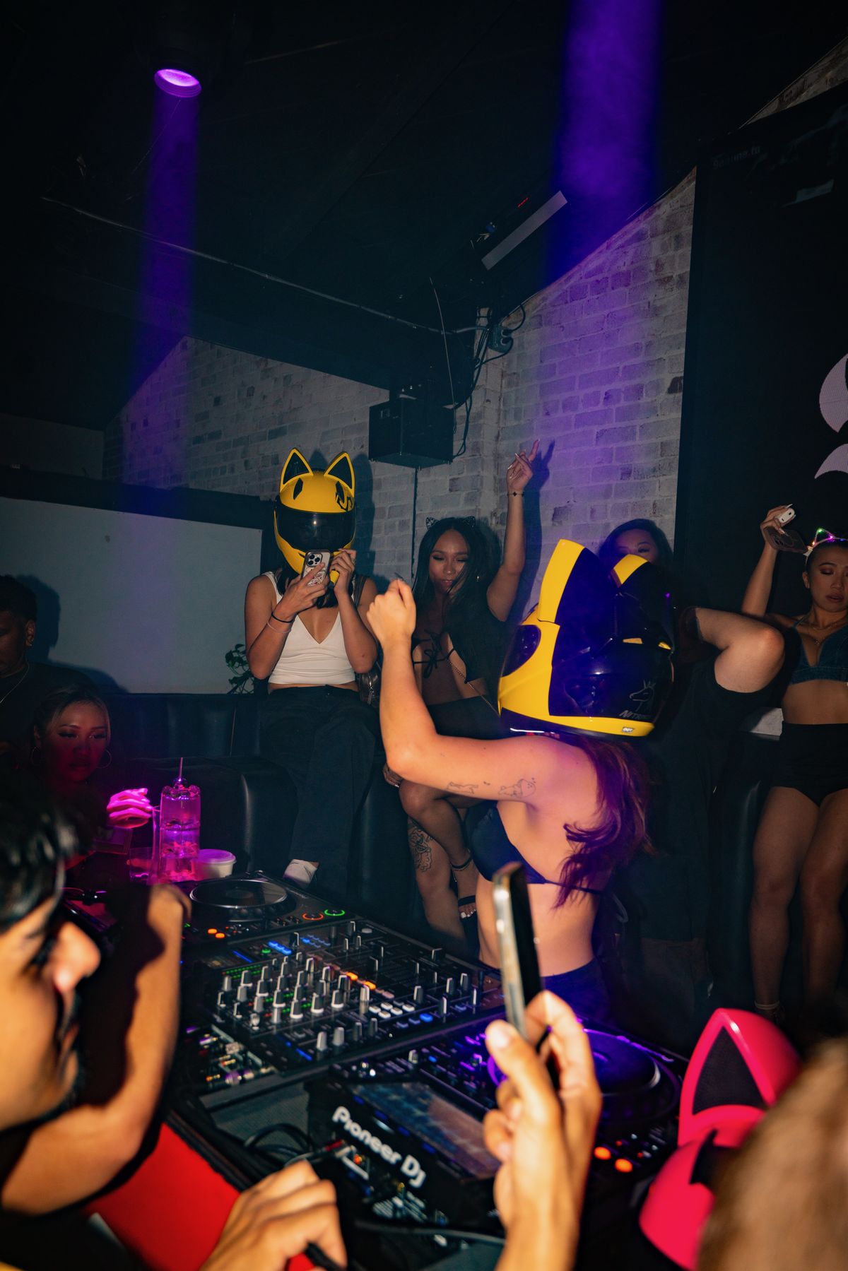 Seduza in the cat ear motorcycle helmet, crowd pressed against the booth